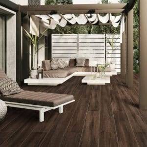 Scandinavian Espresso Brown Wood Look Tile on an outdoor patio, capturing the rich look of hardwood with unmatched resilience. This 100% waterproof porcelain tile offers timeless elegance and effortless care for a beautiful, worry-free outdoor space.