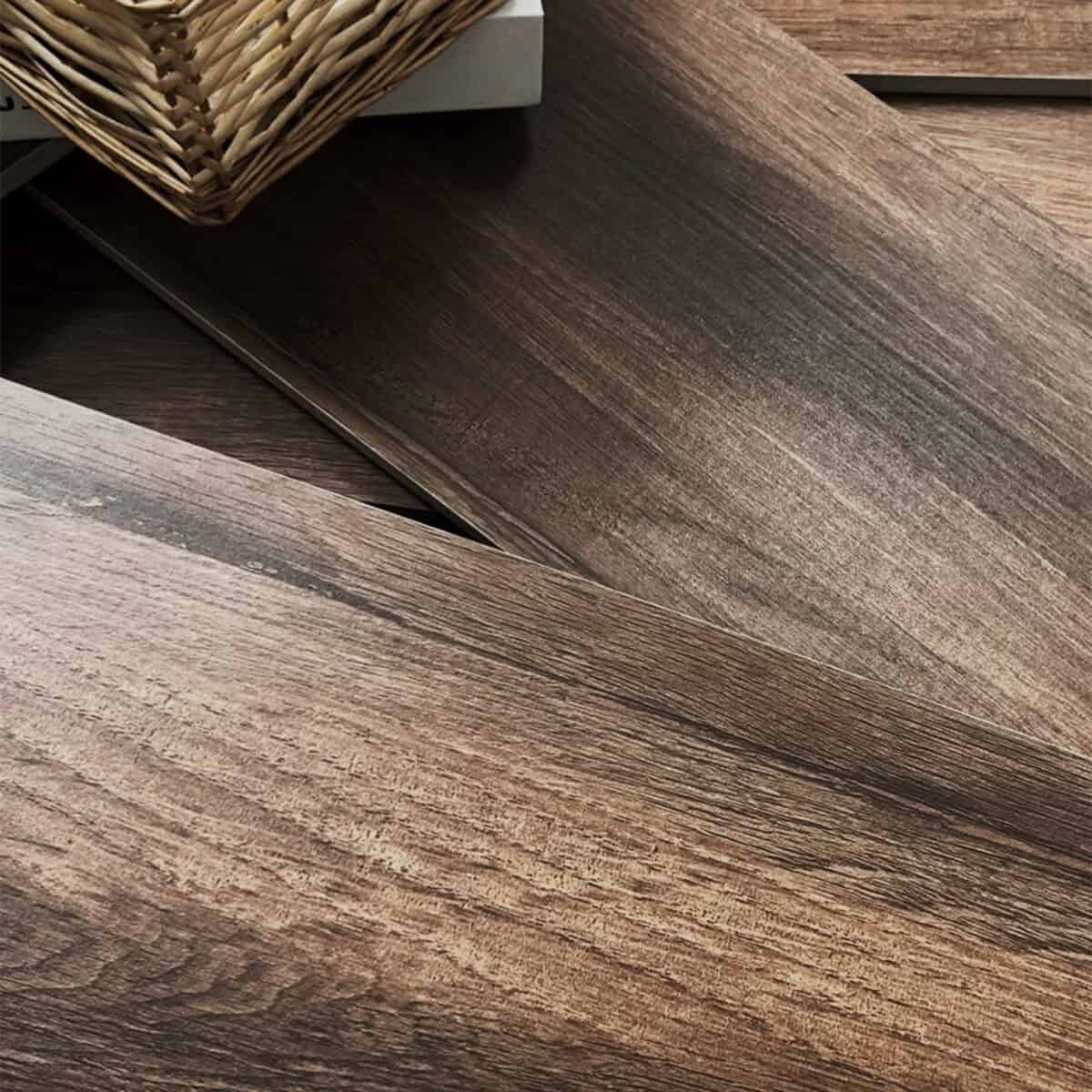Scandinavian Espresso Brown Wood Look Tile pieces displayed, showcasing their rich hardwood look and authentic texture. This 100% waterproof porcelain tile is scratch and stain-resistant, offering effortless care for a worry-free lifestyle.