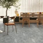 Contemporary Style Stormy Grey Stone Look SPC Vinyl Flooring in a modern dining area, offering a sophisticated canvas with its dynamic gray tones. This 100% waterproof, DIY-friendly SPC flooring resists scratches, stains, and dents, perfect for modern living.