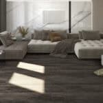 Industrial Loft Charred Pine Wood Look LVT Flooring in a modern living room, channeling a dramatic, authentic industrial loft spirit. This 100% waterproof LVT resists scratches, stains, and dents, offering a bold, character-rich foundation for expressive style.