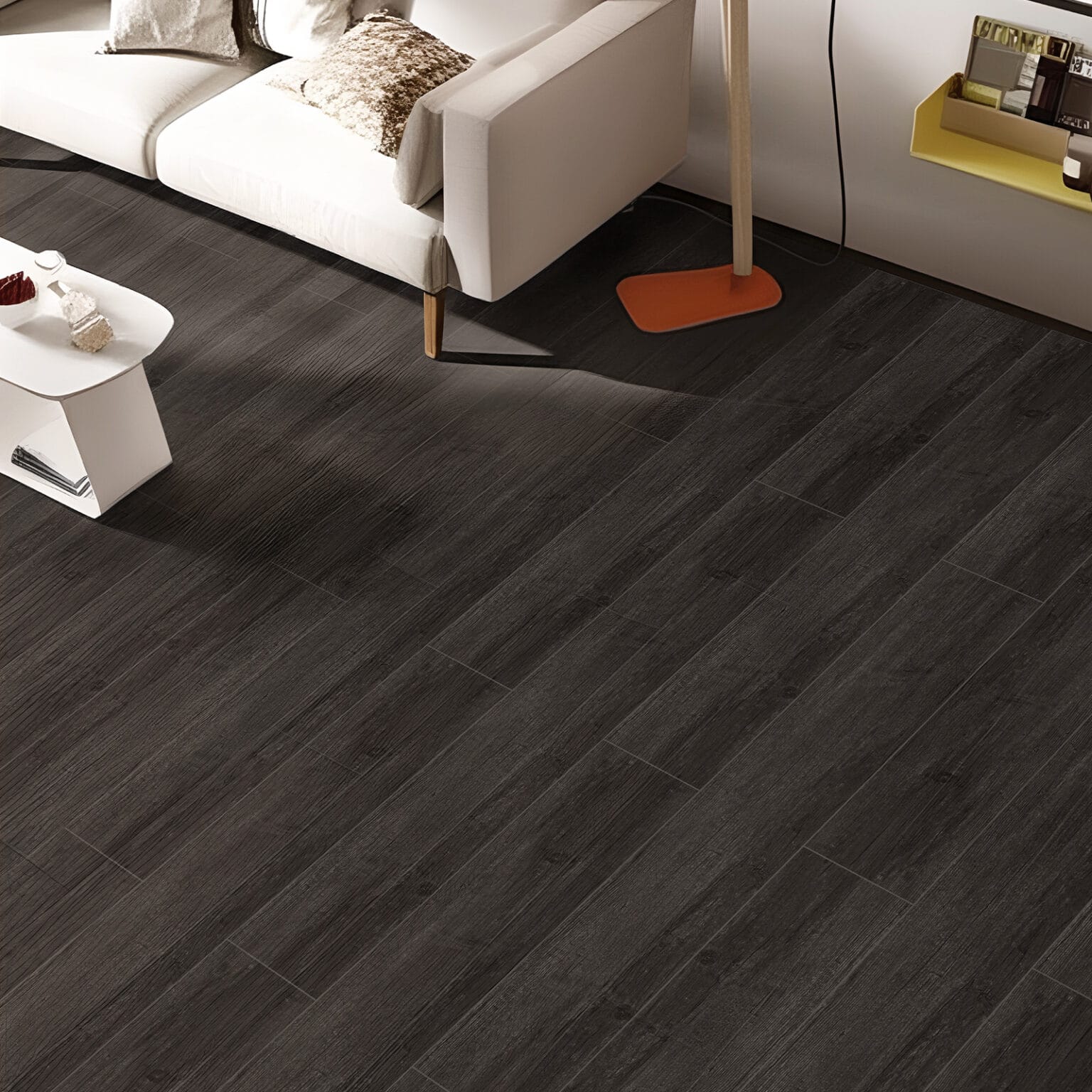 A modern living room from an overhead perspective, where the Bold Industrial Loft Charred Pine Wood Look Vinyl Floor creates a dramatic, grounding contrast with a white sofa and colorful accents.