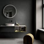 Modern Cool Charcoal Black Wood Look Tile on a bathroom wall, showcasing its deep, cool tones and herringbone pattern. This 100% waterproof porcelain tile offers unmatched durability and easy care for a bold, modern edge.