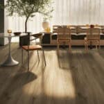 Modern Farmhouse Earthen Oak Wood Look LVT Flooring in a bright kitchen, bringing rustic warmth with its authentic oak grain and earthy tones. This 100% waterproof LVT resists scratches, stains, and dents, offering a durable, easy-to-clean foundation for a cozy, welcoming home.