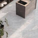 Modern Minimalist Pewter Slate Stock Look Vinyl Flooring in a bright kitchen, offering the refined aesthetic of natural slate. This 100% waterproof vinyl is brilliantly practical for busy areas, providing superior protection against scratches, stains, and dents, ensuring high-end style and peace of mind.