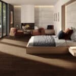 alt="Mountain Lodge Espresso Walnut Wood Look LVT Flooring in a luxurious bed room, bringing deep, enveloping warmth with its dramatic, rich tones. This 100% waterproof LVT resists scratches, stains, and dents, creating a cozy, sophisticated retreat for modern life."