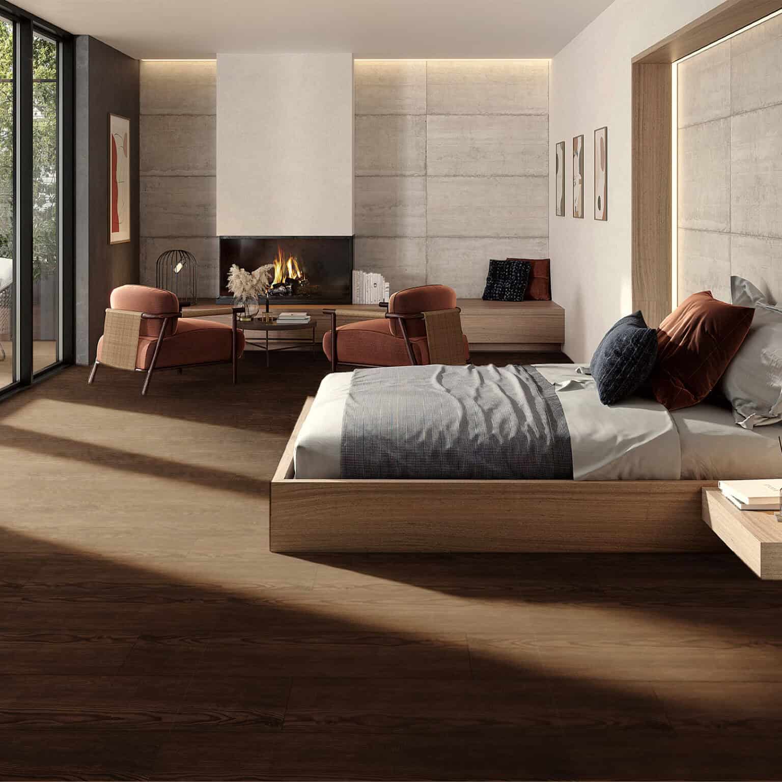 A luxurious, sun-drenched bedroom featuring the Rich Mountain Lodge Espresso Walnut Wood Look Vinyl Floor, which provides a warm, elegant foundation for a modern fireplace and cozy seating area.