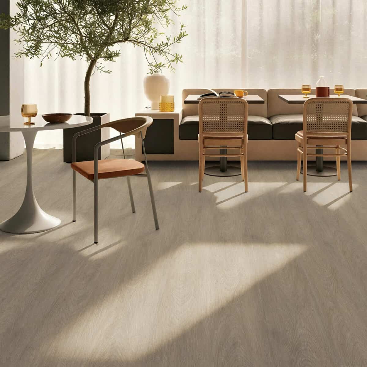 A modern dining room with wooden floors and white walls.
