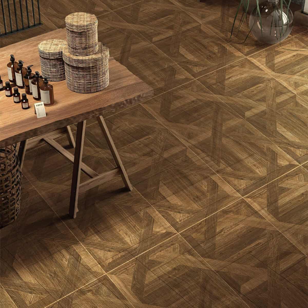 A kitchen/dining area installed with Dynamic Geometric Teak Parquet Wood Look Tile, where its unique geometric parquet pattern complements a wooden table and wicker baskets.