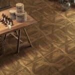A kitchen/dining area installed with Dynamic Geometric Teak Parquet Wood Look Tile, where its unique geometric parquet pattern complements a wooden table and wicker baskets.