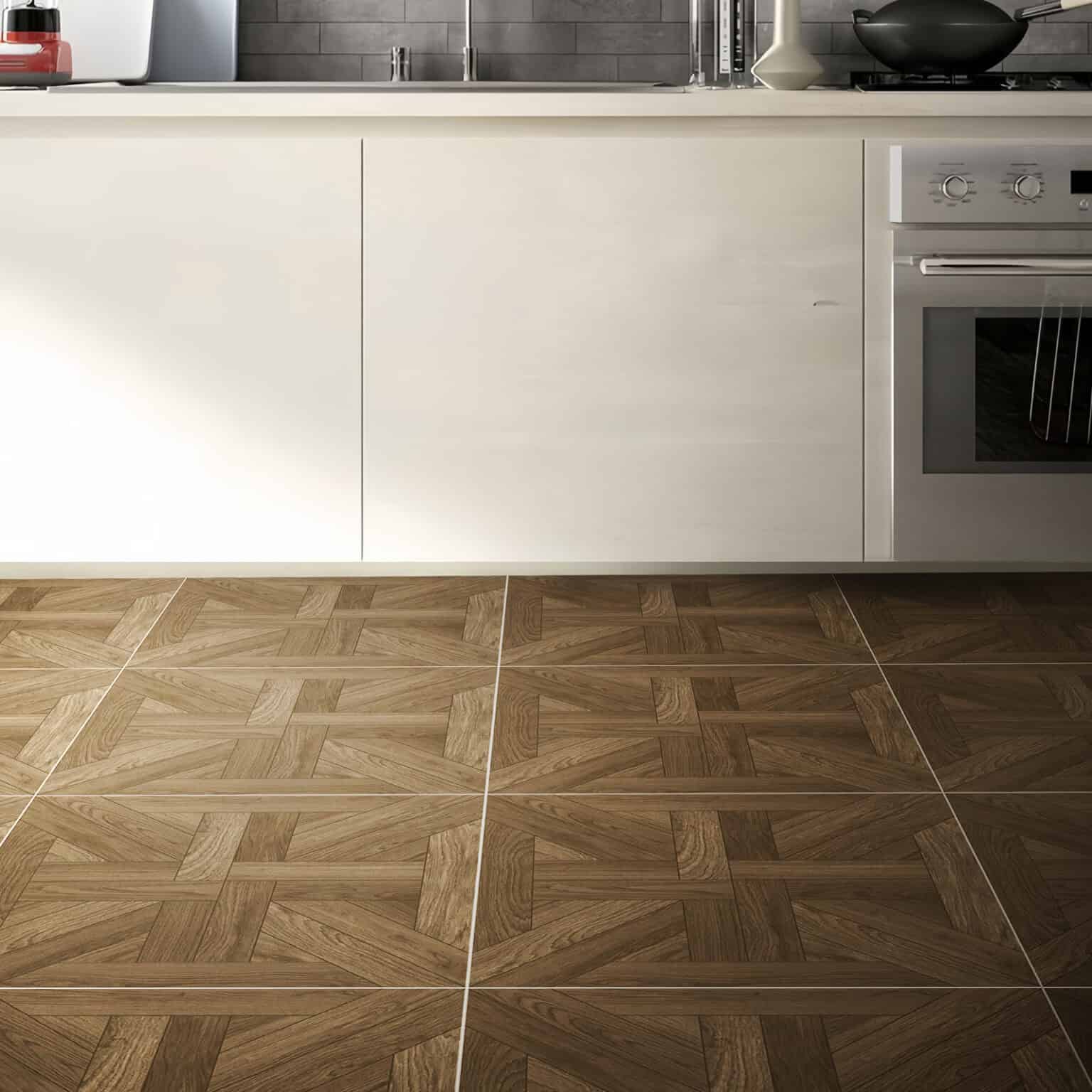 The Umber Tone Walnut Wood Look Tile installed in a modern kitchen with sleek white cabinets, showcasing its elegant French parquet pattern.