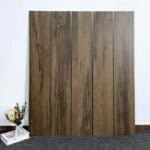 Industrial Smoked Brown Wood Look Tile planks displayed, showcasing their deep, smoked brown tones and authentic wood grain. This 100% waterproof porcelain tile offers unmatched durability, resisting scratches and stains for industrial chic style.