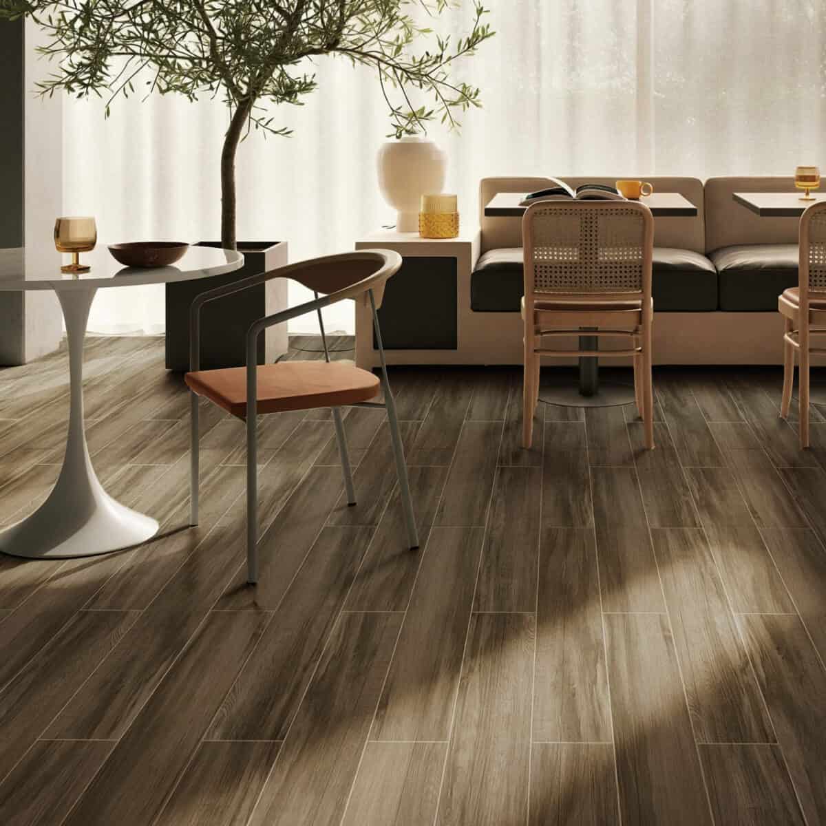 Industrial Smoked Brown Wood Look Tile on a living room floor, enhancing a bold, sophisticated industrial chic design. This 100% waterproof porcelain tile offers unmatched durability, resisting scratches and stains for a worry-free lifestyle.