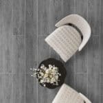 Timeless Classic Stormy Gray Wood Look Click Lock Vinyl Flooring SPC in a stylish living room, creating a space of enduring style with its versatile gray tones. This 100% waterproof, DIY-friendly SPC flooring resists scratches, stains, and dents, perfect for modern elegance.