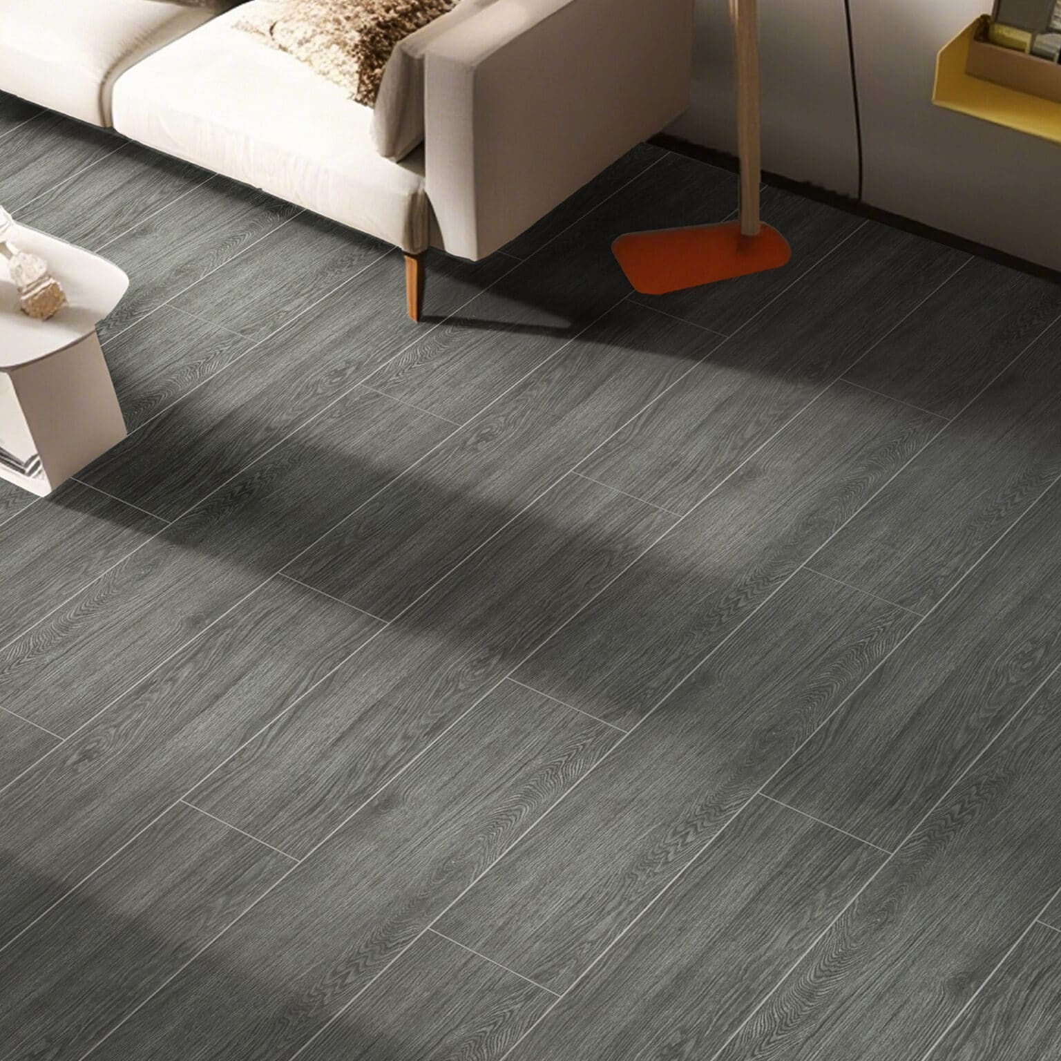 Modern Minimalist Charcoal Gray Wood Look Tile on a living room floor, creating a sophisticated, bold backdrop. This 100% waterproof porcelain tile is scratch and stain resistant, offering effortless care for a worry-free lifestyle.