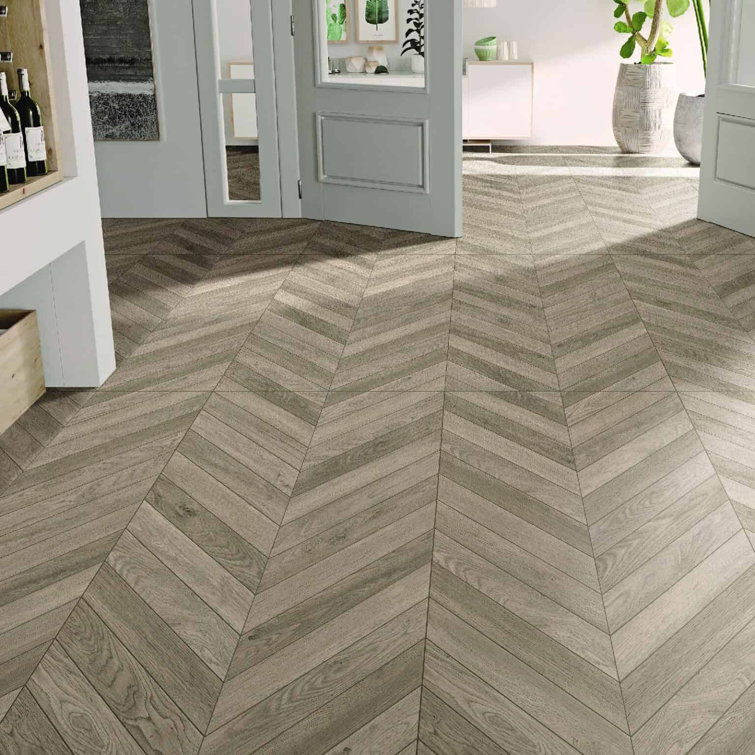 Scandinavian Weathered Wood Color Wood Look Tile in a relaxed living room, creating a bright, rustic atmosphere with its sun-bleached tones. This 100% waterproof porcelain tile offers unmatched durability, resisting scratches and stains for a worry-free lifestyle.