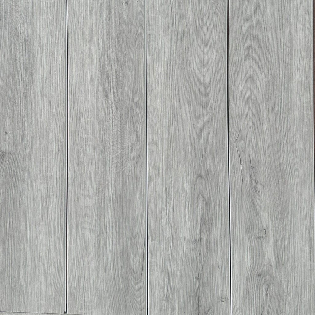 Full layout of Modern Silver wood SPC planks, showcasing the light gray color, subtle knots, and seamless installation.