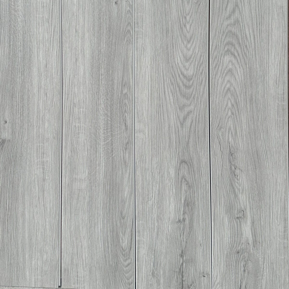 Full layout of Modern Silver wood SPC planks, showcasing the light gray color, subtle knots, and seamless installation.