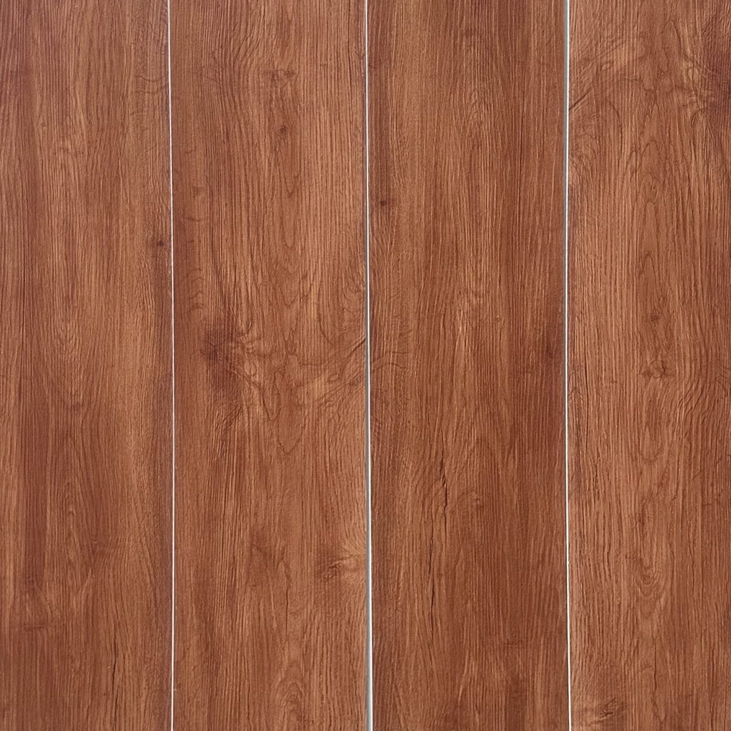 Full view of Contemporary Warm Teak SPC flooring planks showcasing their warm, reddish-brown color and consistent grain.