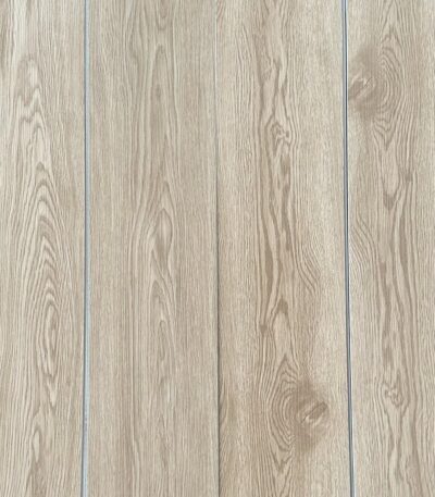 Real-world photograph of Serene Coastal Beige Oak SPC planks laid together, showcasing their seamless, natural wood appearance.