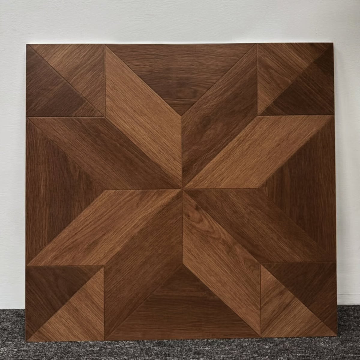 Real photo of a single American Vintage Coffee Brown Wood Look Tile, showcasing its intricate geometric parquet pattern and rich wood grain.