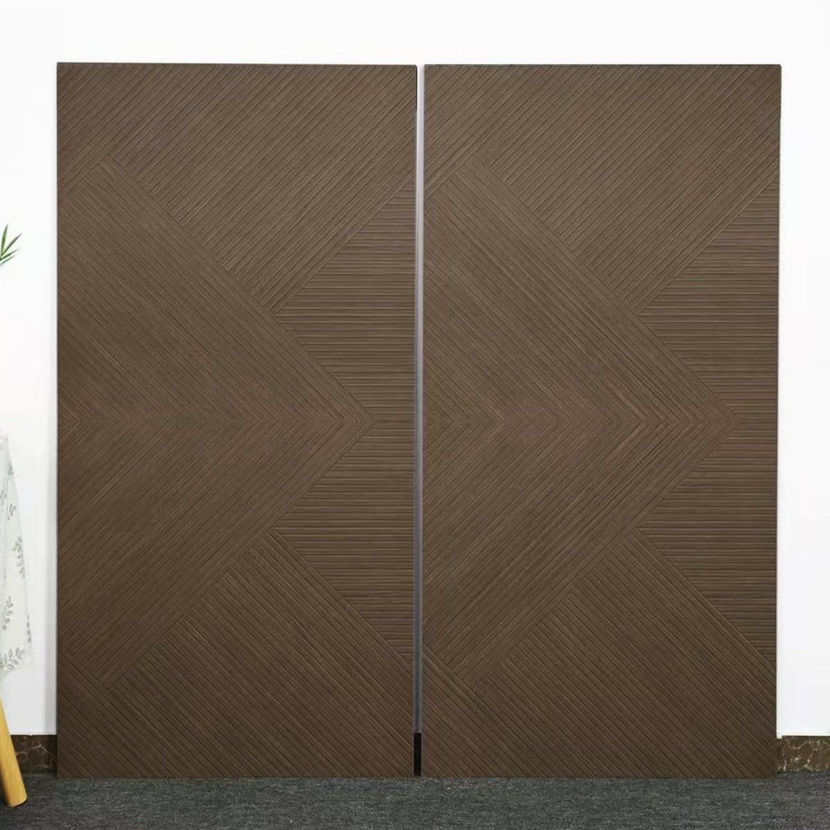 Real photo of Inspired Design Cocoa Brown Wood Look Tile planks, showcasing their intricate geometric pattern and linear, woven-like texture.