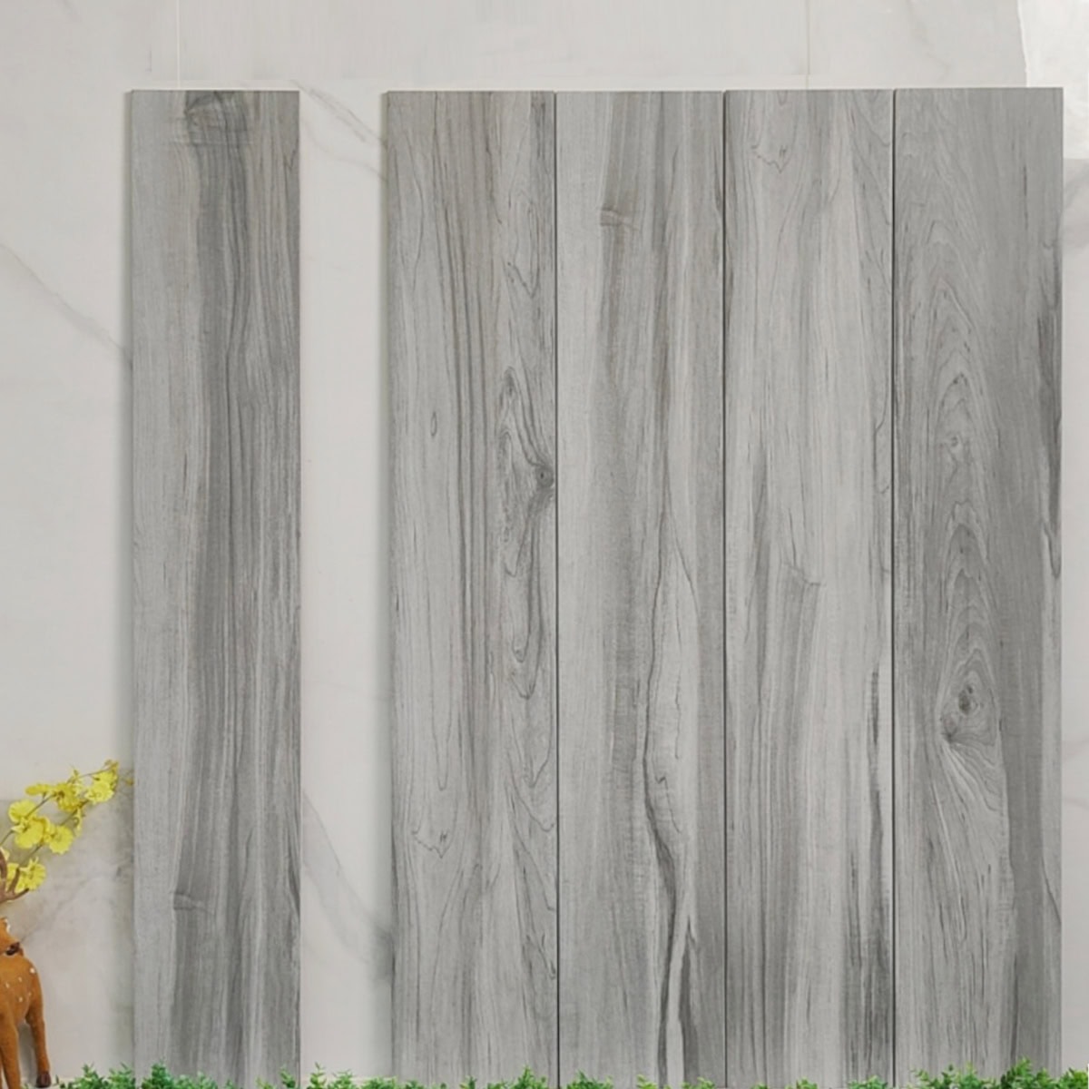 Real photo of Scandinavian Light Gray Oak Wood Look Tile planks, showing their minimalist wood grain and bright, cool-toned color.