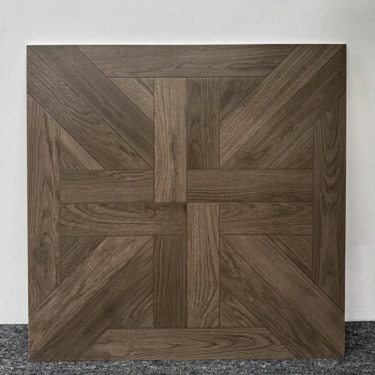 Real photo of a single Stately Dark Walnut Wood Look Tile, showcasing its intricate parquet pattern and rich, deep wood grain tones.